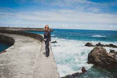 Full length of woman standing in water