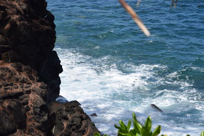 High angle view of rocks in sea