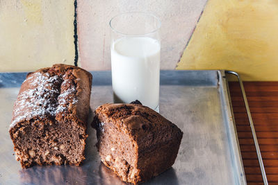 High angle view of chocolate cake with milk glass on table