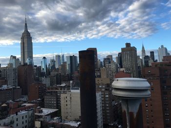 Cityscape against cloudy sky