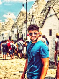 Portrait of smiling young man standing in city