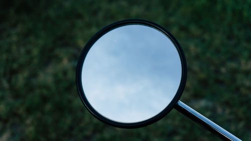 Reflection of sky on field seen through glass