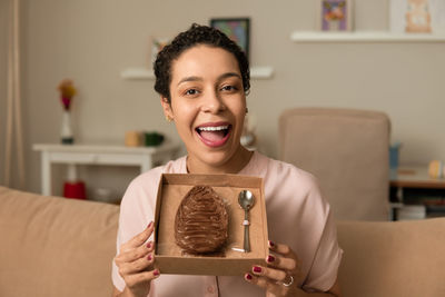 Portrait of young woman using mobile phone at home