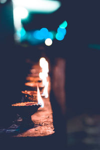 Close-up of lit candle in the dark