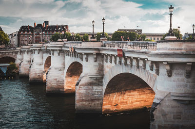 Details of the pont neuf in paris on a cloudy summer sky at the end of the day