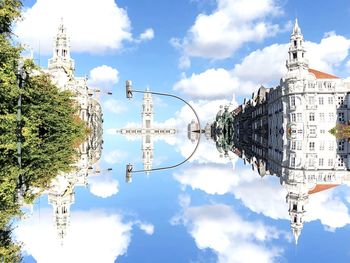 Low angle view of buildings against cloudy sky