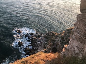 High angle view of rocks on sea shore