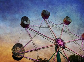 Low angle view of ferris wheel against sky