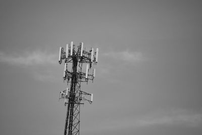 Low angle view of communications tower against sky