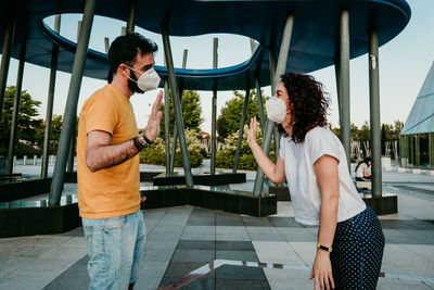 Young couple standing against built structure