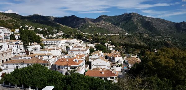 High angle view of townscape and mountains against sky