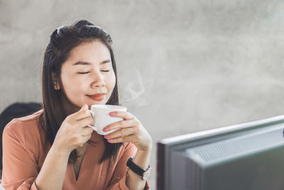 Young woman drinking coffee cup