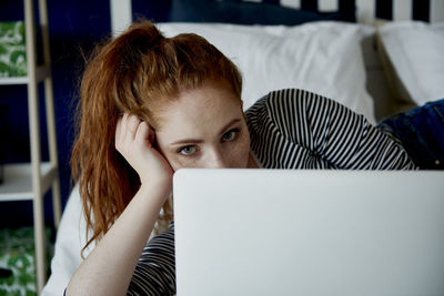 Portrait of mid adult woman using mobile phone at home