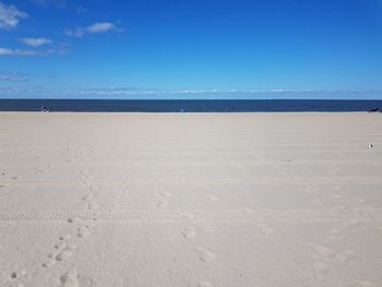 Scenic view of beach against clear blue sky