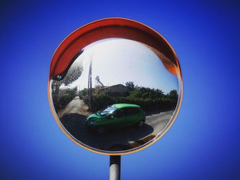 Reflection of vehicle in round mirror