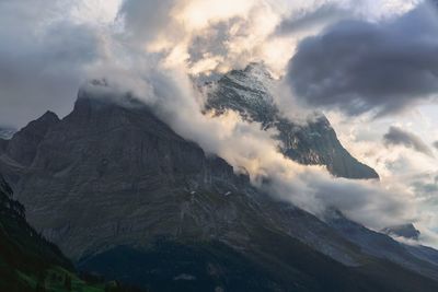 Cloudy scenic morning view of mättenberg mountain against the sky in grindelwald, switzerland