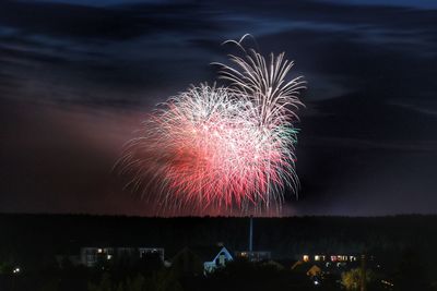 Low angle view of firework display at night