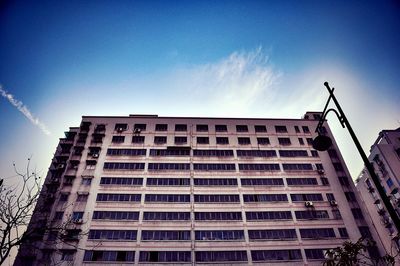 Low angle view of modern building against blue sky