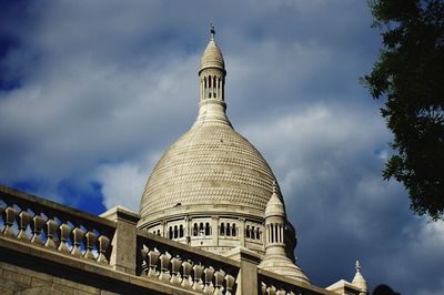 Low angle view of church against cloudy sky