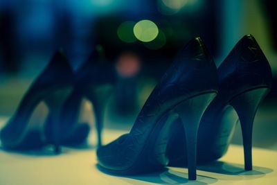 Close-up of high heels on floor at night