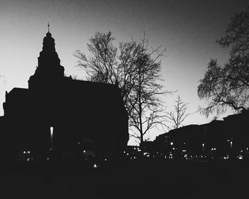 Low angle view of silhouette built structures at sunset