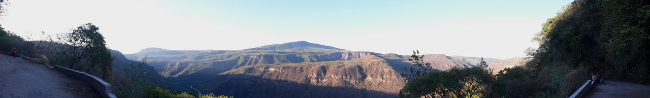 Panoramic view of mountains against clear sky