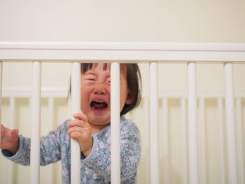 Boy in crib crying at home