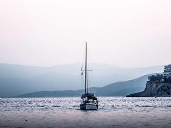 Sailboat sailing on sea against clear sky