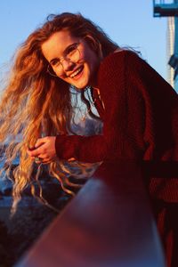 Portrait of smiling young woman sitting outdoors