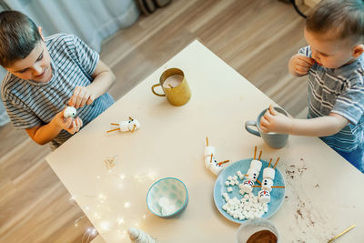 High angle view of people sitting on table