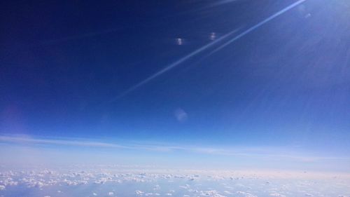 Aerial view of landscape against blue sky