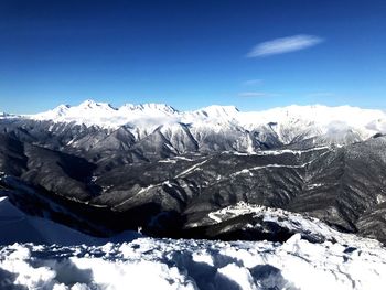 Snowcapped mountains against blue sky