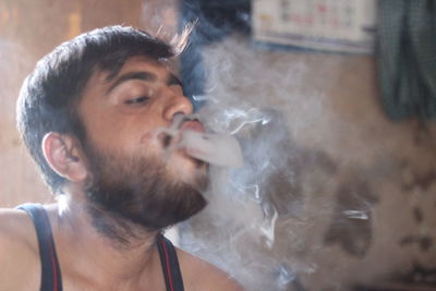 Close-up of man smoking cigarette