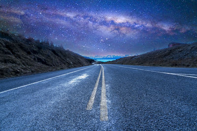 Road against sky at night