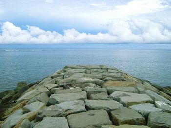 Scenic view of sea against cloudy sky