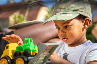 Portrait of cute boy playing with toy