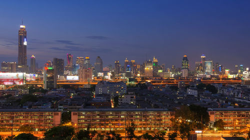 Illuminated cityscape against sky at night