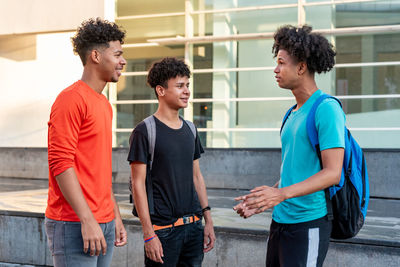 Fiends talking while standing outdoors