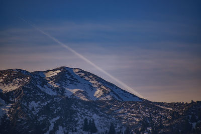 Scenic view of snowcapped mountains against sky during sunset