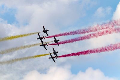 Low angle view of airshow against sky