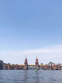 River amidst buildings against sky in city