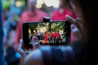 Close-up of man photographing using mobile phone