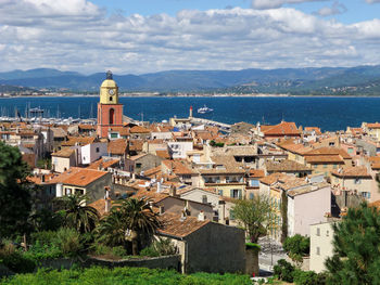 Townscape by sea against sky in city