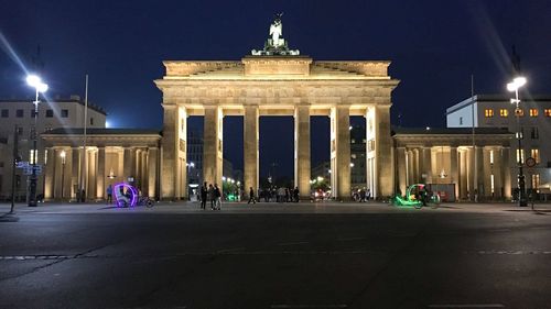 Statue in city at night