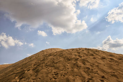 Low angle view of arid landscape against sky