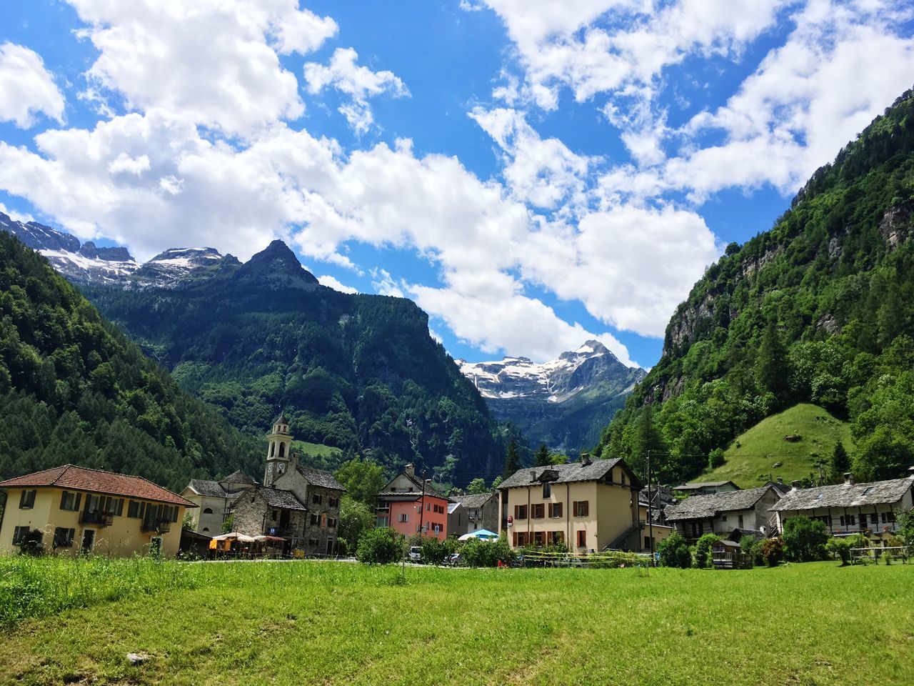 mountain, architecture, building, built structure, cloud - sky, building exterior, plant, grass, house, sky, landscape, scenics - nature, land, nature, beauty in nature, environment, mountain range, day, green color, residential district, no people, outdoors, mountain peak