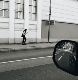 Full length of man on street against building in city