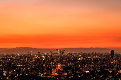 Aerial view of cityscape against sky during sunset