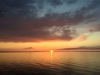 Scenic view of sea against orange sky