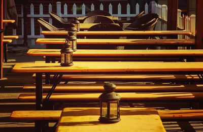 Empty wooden tables and chairs at cafe